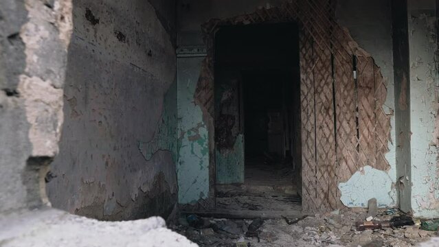 Shooting a broken corridor in a ruined abandoned house. The camera moves smoothly filming this mess