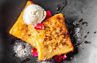 french toast with ice cream on black plate