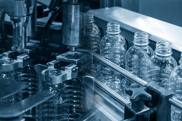 The abstract scene of plastic processing of PET bottles in the drinking water factory.