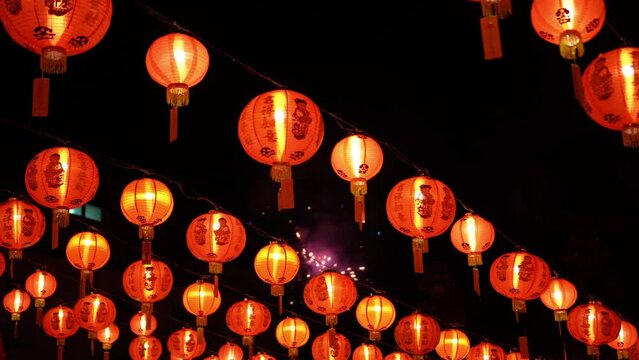 Select focus fireworks at the background of illuminated red chinese new year lantern