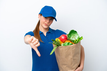 Young delivery woman taking a bag of takeaway food isolated on white background showing thumb down with negative expression