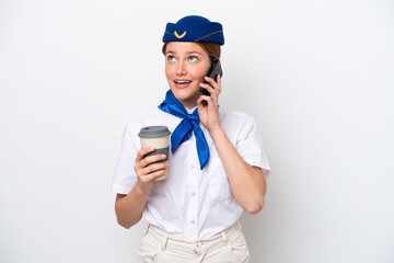 Airplane stewardess woman isolated on white background holding coffee to take away and a mobile