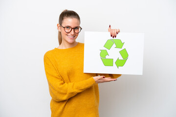 Young caucasian woman isolated on white background holding a placard with recycle icon with happy expression