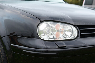 Obraz na płótnie Canvas Close-up photo of car lights on a rainy day