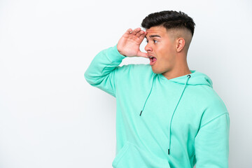 Young caucasian handsome man isolated on white background with surprise expression while looking side