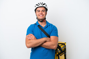 Young caucasian man with thermal backpack isolated on white background keeping the arms crossed in frontal position