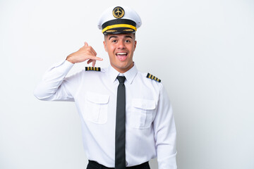 Airplane pilot caucasian man isolated on white background making phone gesture. Call me back sign