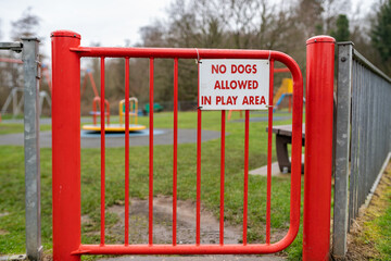 Sign at the entrance of a children's play area saying that dogs are not allowed