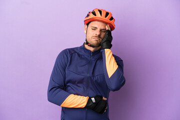Young Brazilian cyclist man isolated on purple background with headache - obrazy, fototapety, plakaty