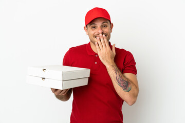 pizza delivery man with work uniform picking up pizza boxes over isolated  white wall happy and...