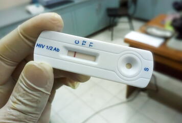 Hand holding Rapid test cassette for HIV type 1 an type 2 antibody test.