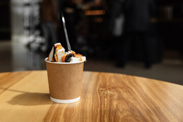 Ice cream with coffee in a disposable cup to take away. Isolated paper cup with ice cream on the...