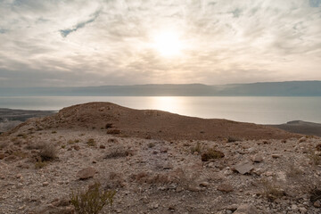 View  from a mountain near the Tamarim stream on the Israeli side of the Dead Sea at sunrise over the Dead Sea and over the mountains on the Jordan side near Jerusalem in Israel