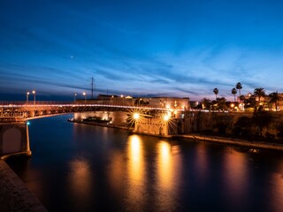 Fototapeta na wymiar Ponte San Francesco di Paola bridge and Castello Aragonese castle in Taranto, Italy at night