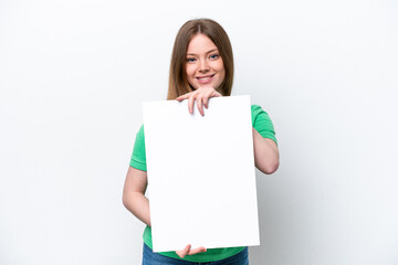Young caucasian woman isolated on white background holding an empty placard with happy expression