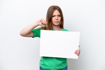 Fototapeta premium Young caucasian woman isolated on white background holding an empty placard and doing bad signal