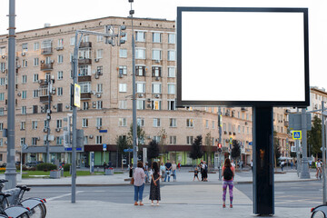 Blank horizontal large billboard in the city. Brick residential building with balconies, the townspeople at the crossing. Mock-up.