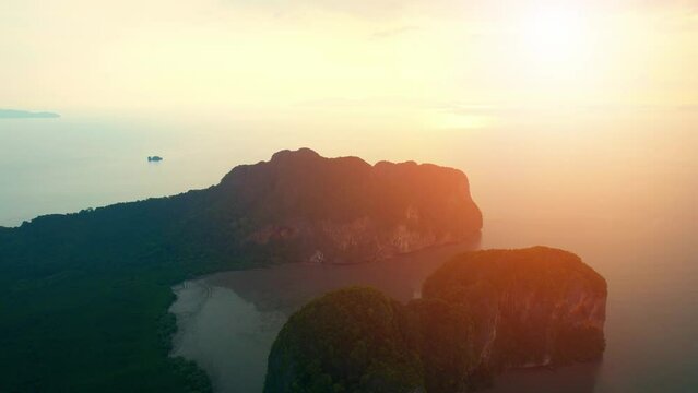 Aerial view over the bay, beautiful limestone mountains on the beach during sunset time. Flight above sea.  &ldquo;Underwater Wedding Beach&rdquo; Trang, Thailand. 4k drone footage
