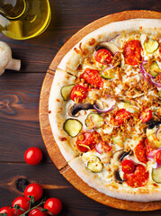 Pizza with mushrooms, champignons, vegetables, mozzarella cheese and fried onions. Freshly baked vegetarian dish. Menu of cafes, pizzeria, restaurant. Close up. Copy space. Fresh champignons, cherry