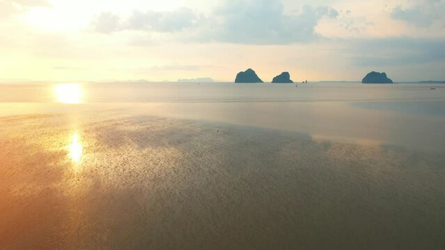 Aerial view from a drone over the beach at low tide. silhouette of beautiful limestone mountains during sunset. &ldquo;Underwater Wedding Beach&rdquo; Trang, Thailand. 4k drone footage
