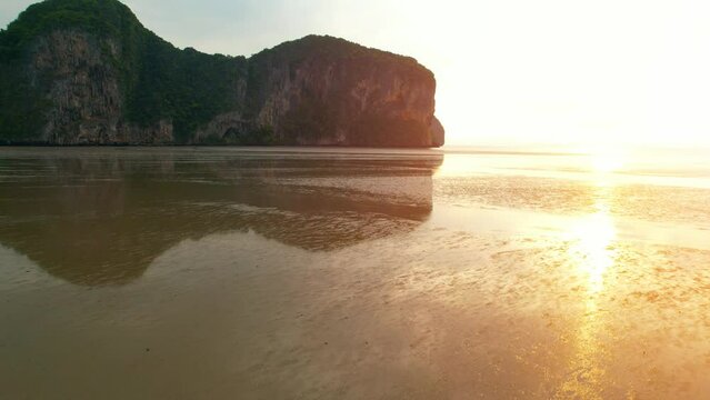 A view from a drone flying over rocky mountains and sandy beaches at low tide. reflection of nature. Flight above sea.  &ldquo;Underwater Wedding Beach&rdquo; Trang, Thailand. 4k drone footage
