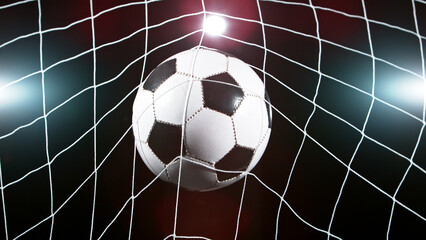 Soccer ball in goal, isolated on black background