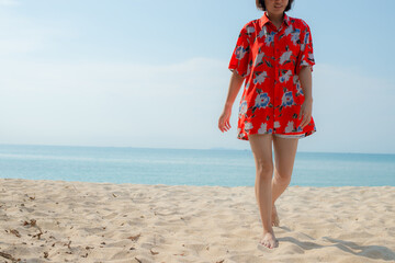 Portrait beautiful young asian woman relax walking leisure around sea beach ocean with white cloud on blue sky in travel vacation