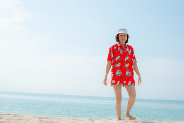 Portrait beautiful young asian woman relax walking leisure around sea beach ocean with white cloud on blue sky in travel vacation