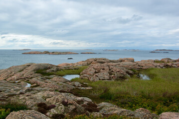 Fototapeta na wymiar Landscape with ocean and red granite boulders on the Swedish west coast.