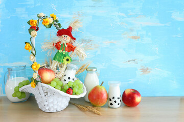 Photo of dairy products over wooden table. Symbols of jewish holiday - Shavuot