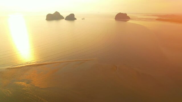 A view from a drone flying over rocky mountains and sandy beaches at low tide. reflection of nature. Flight above sea.  &ldquo;Underwater Wedding Beach&rdquo; Trang, Thailand. 4k drone footage
