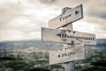 time management skills text quote written in wooden signpost outdoors in nature. Moody theme feeling.