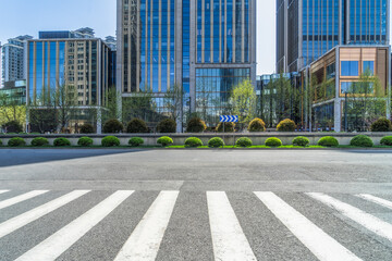 empty road with zebra crossing and skyscrapers in modern city.