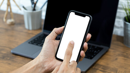 Hands of a businessman using a  smartphone mockup at his desk, Mobile phone blank screen for editing graphics.
