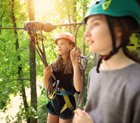 female young friends in a rope park on a sunny day - 500721686
