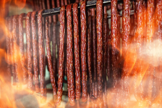 kabanos sausages are prepared on fire in a butcher's shop