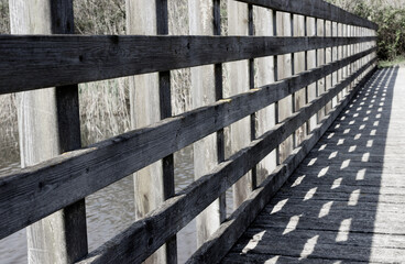 Architecture background. Detail of a wooden walkway with shadows.