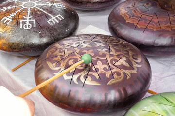 Glucophones or tank drums with wooden sticks are sold at a street stall. Ethnic musical instruments
