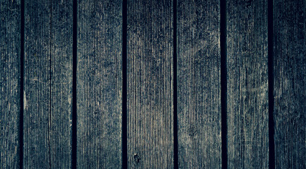 Natural dark background. Old wooden planks with knots. Gray rough background.