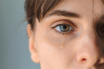Tears on woman face, beauty girl cry on black background.