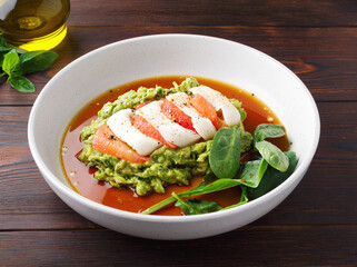 Healthy snack with avocado, squid, grapefruit and basil. Close up. Mashed avocado puree, sauce, seafood. Copy space. The concept of healthy eating. Healthy food. Top view. Wooden background. Diet food