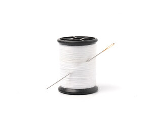 Sewing thread and needle isolated on white background.