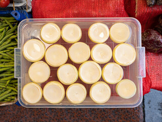 top view of group of fresh artichokes hearts in plastic bowl