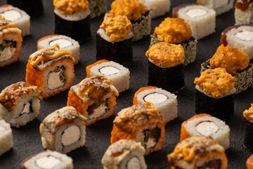 Solid background of japanese sushi rolls with fresh fish - obrazy, fototapety, plakaty