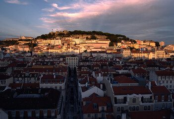 Fototapeta na wymiar Cityscape by sunset with cloudy sky in the background, Lisbon, Portugal. Touristic sightseeing 