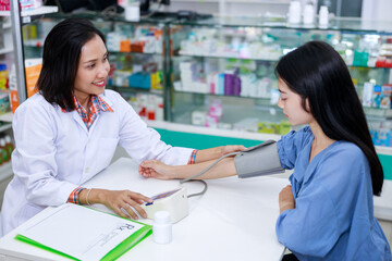Doctor female Measuring arterial blood pressure young woman patient in clinic
