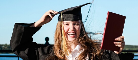 Cute teenage graduate girl laughing and having fun. No school, back to school concept. Graduation. Education. Banner.