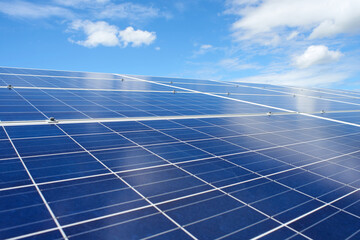 Solar panels energy farm on sky background