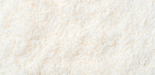 Small coconut chips, culinary background. Top view