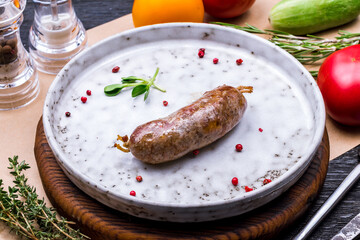 lamb kupaty on grey plate on wooden board